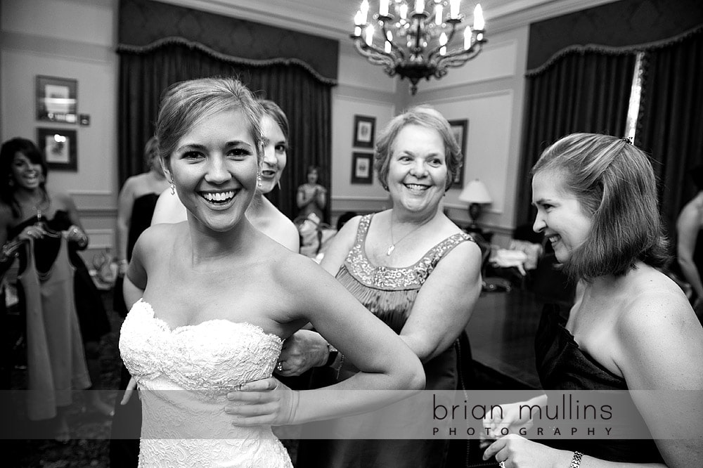 Bride getting into her wedding dress