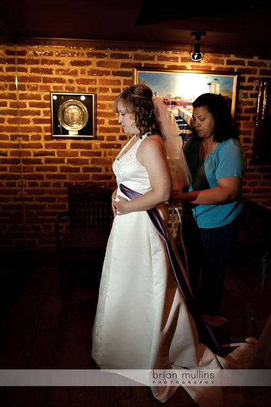 bride putting on dress