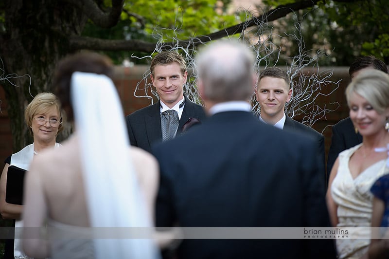 groom watching bride walk down aisle