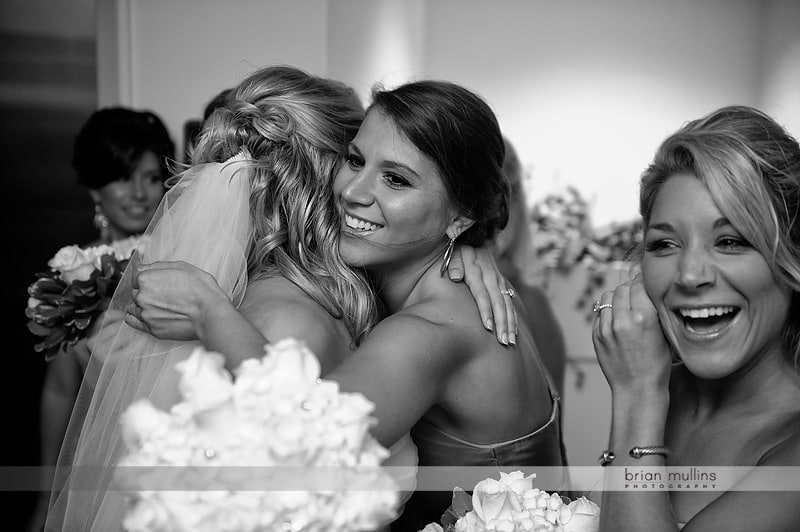 bride and bridesmaid hugging