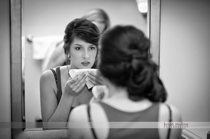 bridesmaid putting on lipstick