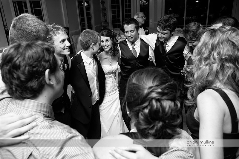 bride and groom dancing with friends